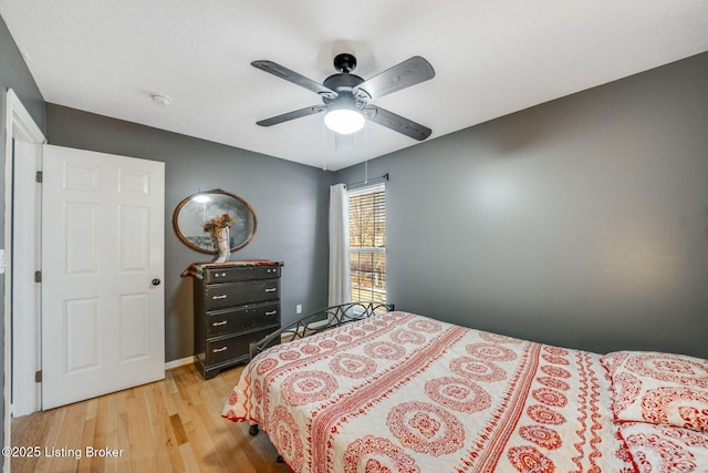 bedroom with ceiling fan and light hardwood / wood-style flooring