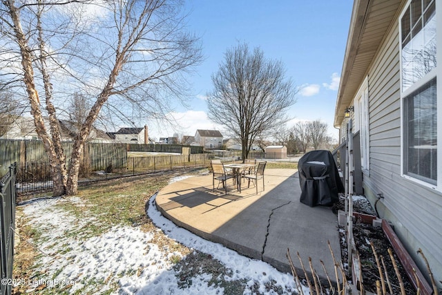 yard layered in snow featuring a patio area