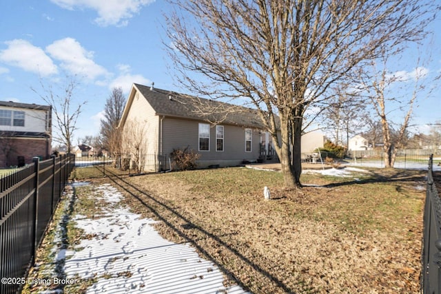 view of side of home with a yard