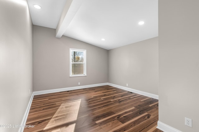 spare room with vaulted ceiling with beams and dark hardwood / wood-style floors