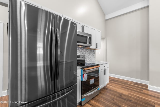 kitchen featuring backsplash, white cabinetry, dark wood-type flooring, appliances with stainless steel finishes, and high vaulted ceiling