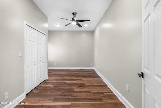 interior space with ceiling fan and dark wood-type flooring