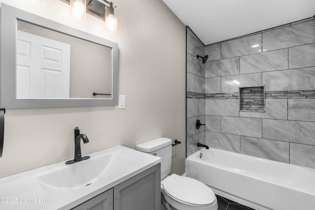 full bathroom featuring toilet, tiled shower / bath combo, tile patterned floors, and vanity