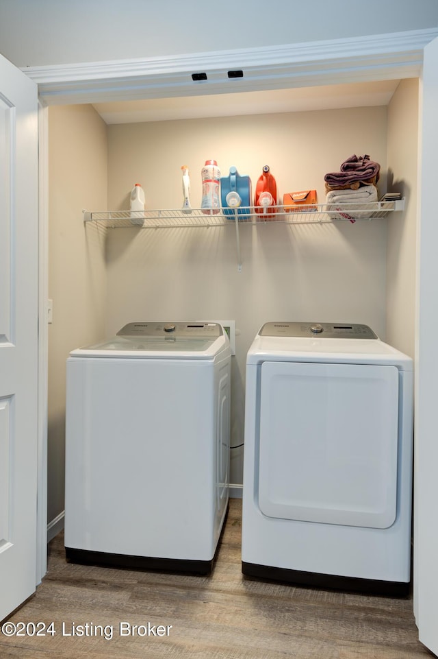 clothes washing area with light hardwood / wood-style floors and separate washer and dryer