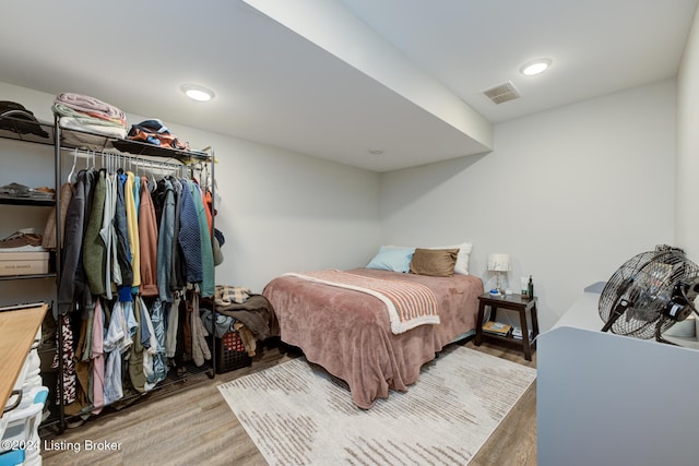 bedroom with hardwood / wood-style flooring