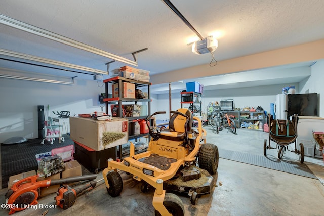 garage featuring a garage door opener and stainless steel fridge