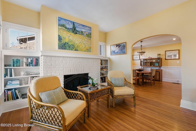 living area featuring hardwood / wood-style flooring and a fireplace