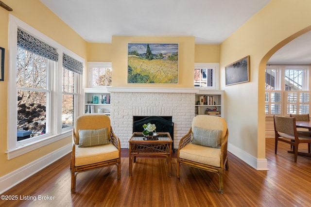 sitting room with hardwood / wood-style flooring and a fireplace