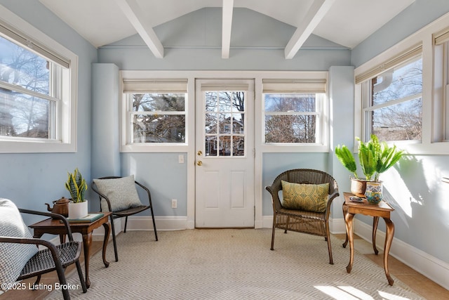 sunroom with vaulted ceiling with beams