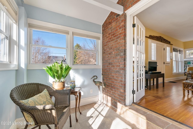 living area featuring hardwood / wood-style flooring and vaulted ceiling