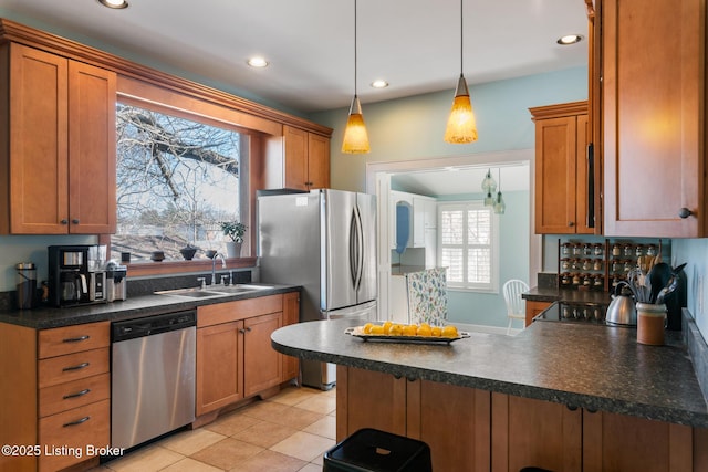 kitchen with pendant lighting, sink, stainless steel appliances, light tile patterned flooring, and kitchen peninsula