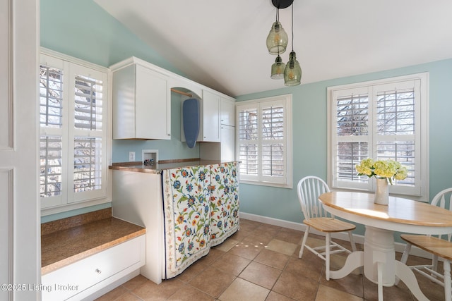 kitchen featuring light tile patterned flooring, pendant lighting, and white cabinets