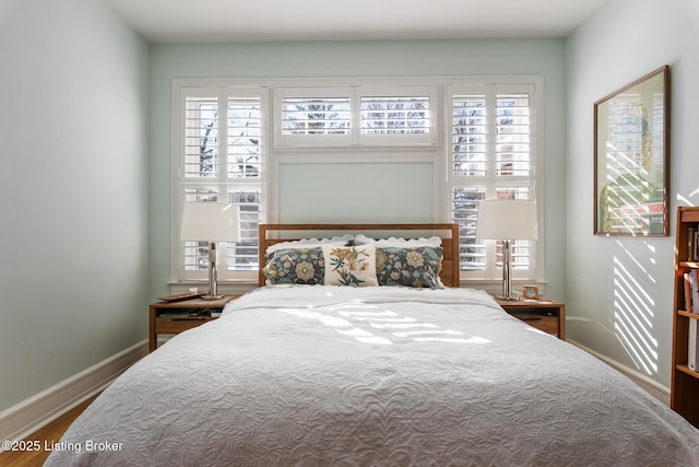 bedroom featuring multiple windows and hardwood / wood-style floors