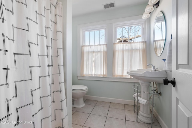 bathroom with tile patterned floors and toilet