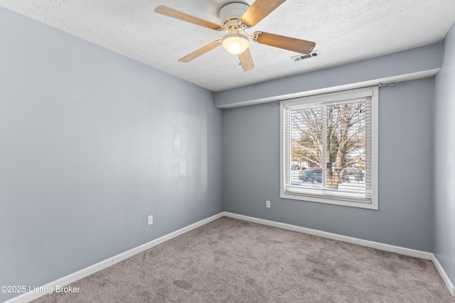 unfurnished room with light carpet, ceiling fan, and a textured ceiling