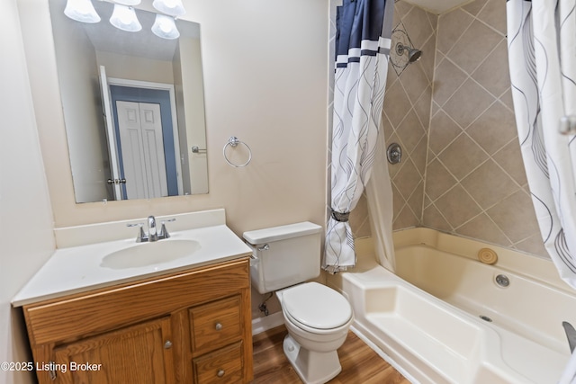 full bathroom featuring hardwood / wood-style floors, toilet, vanity, and shower / bath combo