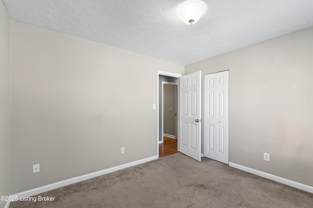 unfurnished bedroom with a closet and carpet