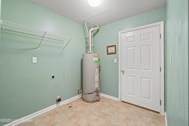 laundry area featuring water heater, a textured ceiling, and hookup for an electric dryer