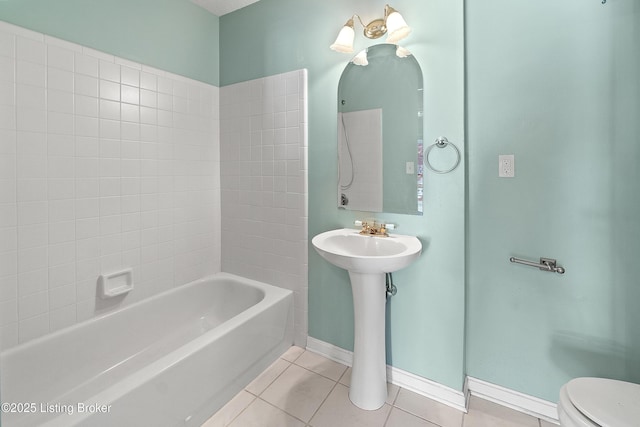 bathroom with tile patterned flooring, washtub / shower combination, and toilet