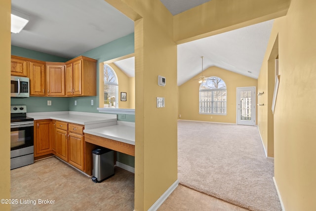 kitchen featuring vaulted ceiling, light colored carpet, ceiling fan, and appliances with stainless steel finishes