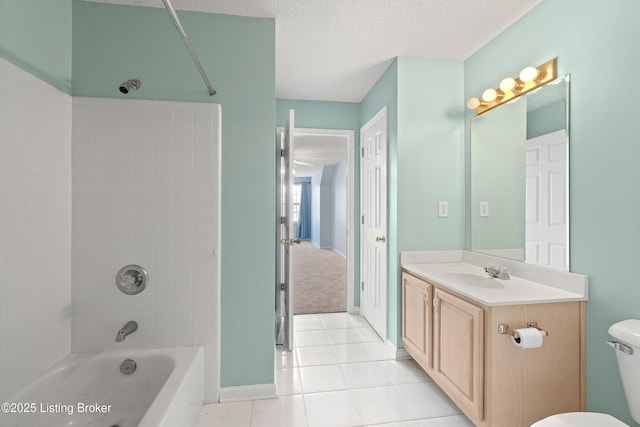 full bathroom featuring toilet, a textured ceiling, vanity, tiled shower / bath combo, and tile patterned flooring