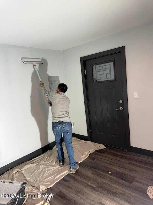 entrance foyer featuring baseboards and wood finished floors