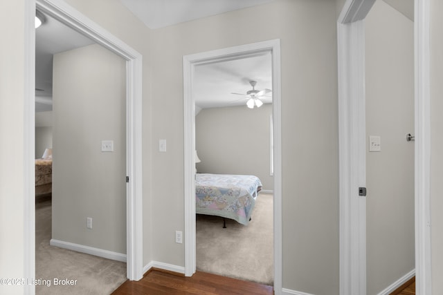 hallway with lofted ceiling and carpet floors