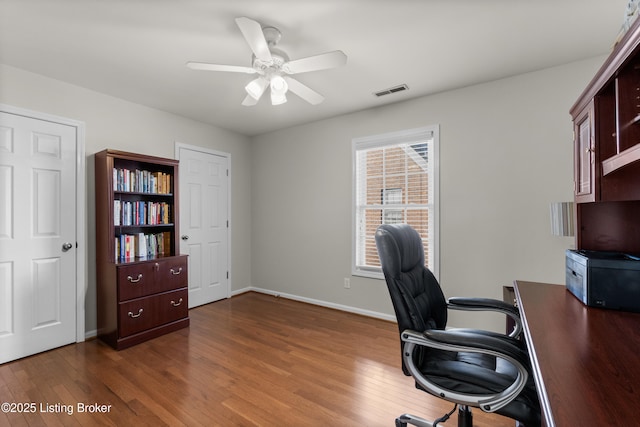 office featuring dark hardwood / wood-style flooring and ceiling fan