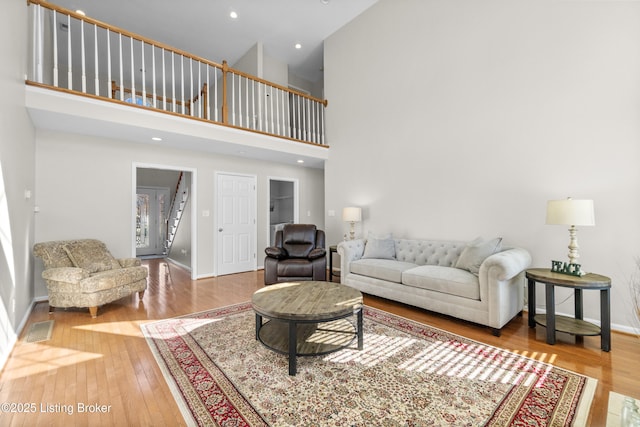 living room with hardwood / wood-style floors and a high ceiling