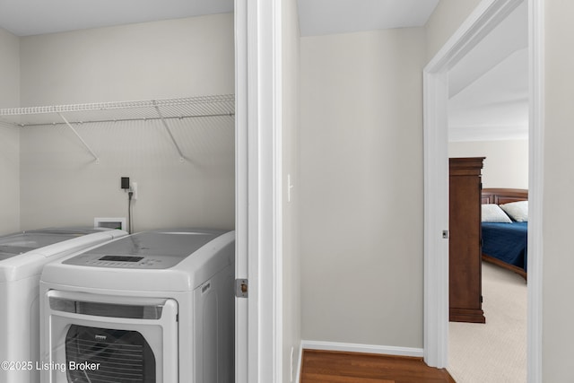 laundry area with wood-type flooring and washer and dryer