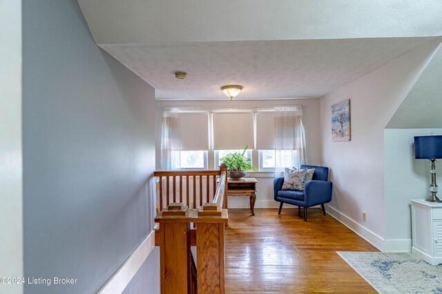 living area with light hardwood / wood-style floors and a textured ceiling