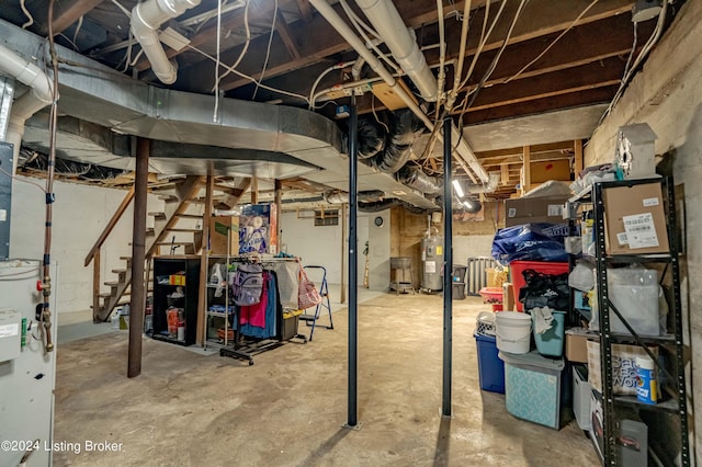 basement featuring water heater and electric water heater