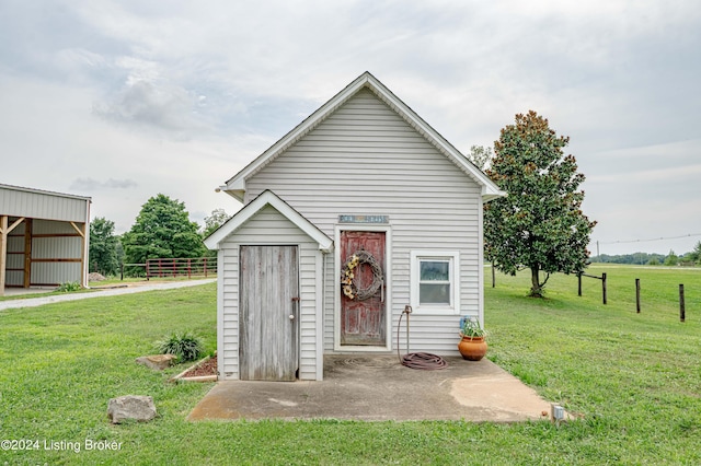 view of outbuilding featuring a yard