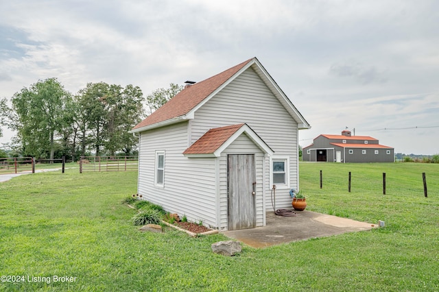 view of outdoor structure featuring a lawn