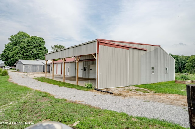 view of outdoor structure with a garage and a lawn