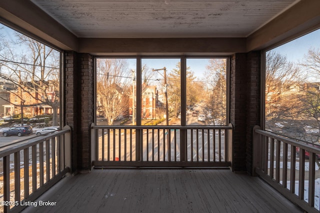 unfurnished sunroom with wood ceiling