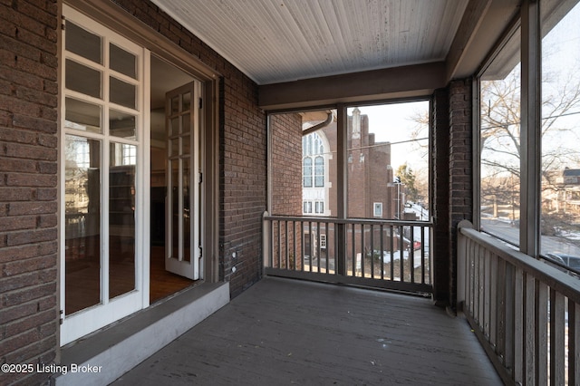 unfurnished sunroom with wooden ceiling