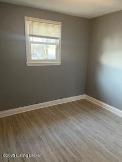 spare room featuring hardwood / wood-style flooring