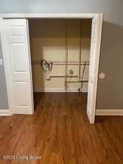 laundry room featuring dark wood-type flooring