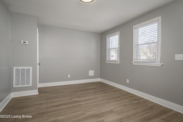 spare room with wood-type flooring