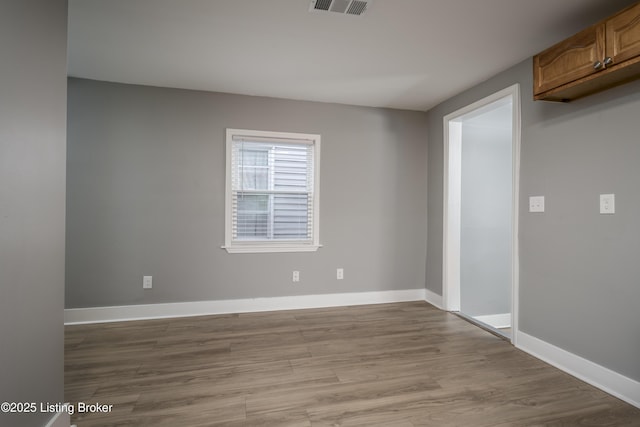 spare room with light hardwood / wood-style floors