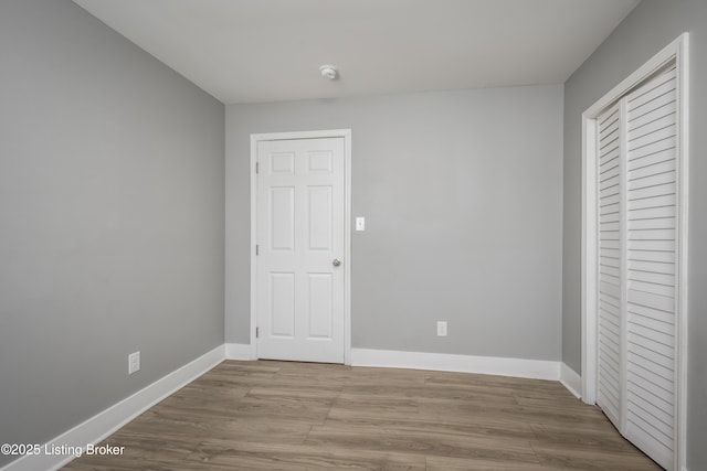 unfurnished bedroom featuring light wood-type flooring and a closet