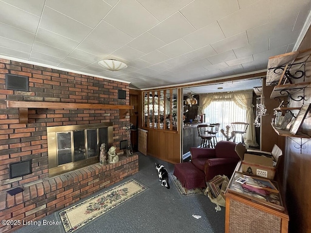 living room with a brick fireplace