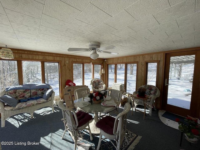 dining space with ceiling fan and carpet