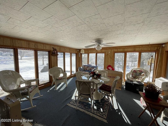 carpeted dining space featuring ceiling fan