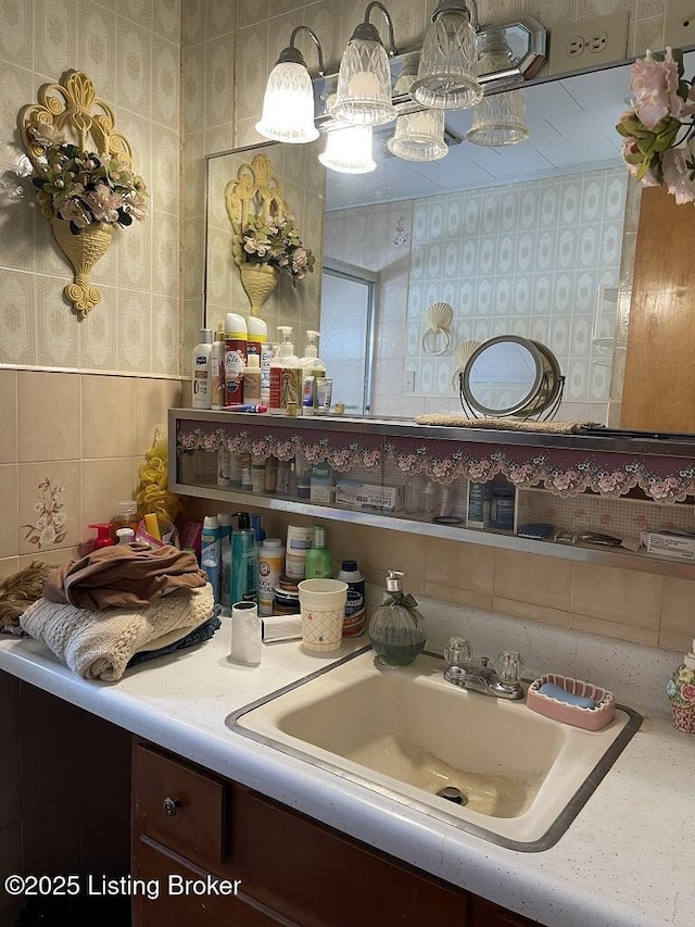 bathroom with tile walls and vanity