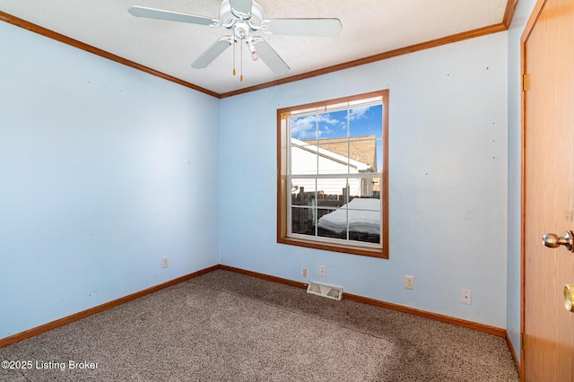 spare room featuring ceiling fan, ornamental molding, and carpet