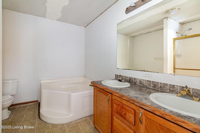 bathroom featuring a bathtub, vanity, and toilet