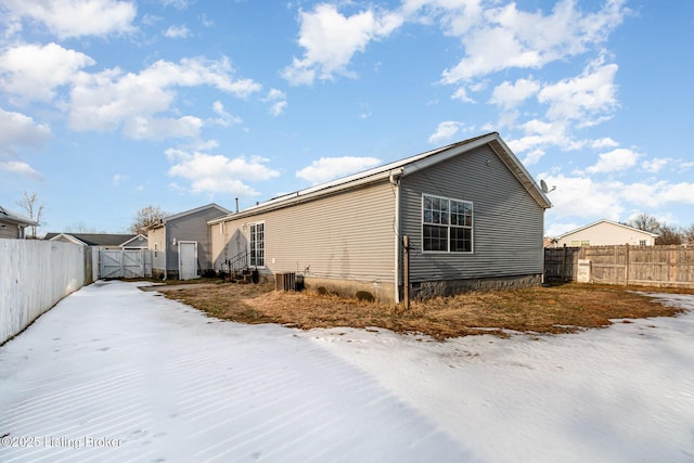 view of snowy exterior featuring central AC