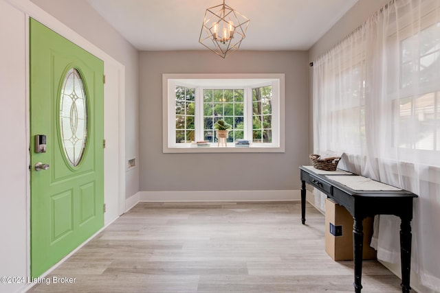 entryway featuring an inviting chandelier and light hardwood / wood-style flooring